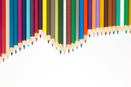 Wave patten of multiple colour wooden pencil on white backgroundの写真素材