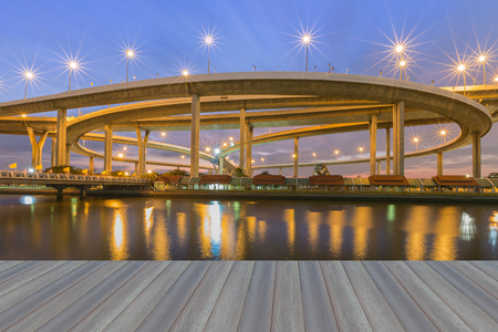 Opening wooden floor, Suspension Bridge across the river at twilight, The Industrial Ring Road Bangkok, Thailandの写真素材