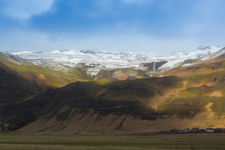 Beautiful Landscape of Icelandic mountain with show cover on top and clear blue sky during late winterの写真素材
