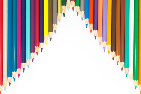 Line of wooden pencils multiple colours on white backgroundの写真素材