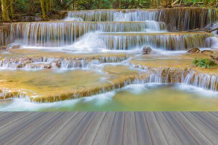Opening wooden floor, close up beautiful blue stream water falls in deep national parkの写真素材