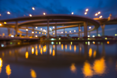 Abstract blurred bokeh Huge elevated crossroad during twilight with water reflectionの写真素材