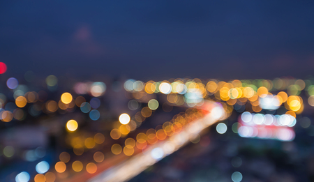 Night blurred bokeh city highway curved during busy hoursの写真素材