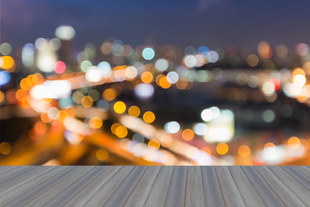 Opening wooden floor, Abstract blurred bokeh city freeway with city background during twilightの写真素材