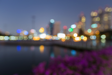 Blurred bokeh lights, office building and water reflection, in public parkの写真素材