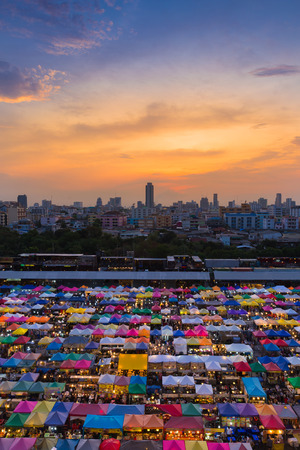 Dramatic sky during sunset over city night marketの写真素材