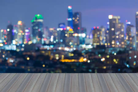 Opening wooden floor, Blurred bokeh lights city office tower night viewの写真素材