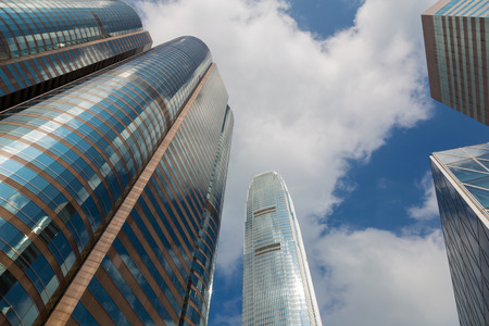 Office building againts blue sky, city downtown business district buildingの写真素材