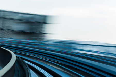 Abstract blurred motion moving train curved backgroundの写真素材