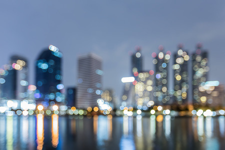 Night blurred bokeh lights office building and reflection abstract backgroundの写真素材