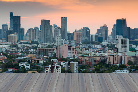 Opening wooden floor, city office building business downtown with sunset sky backgroundの写真素材