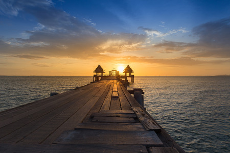 Wooden path walking way leading to ocean with beautiful sunset sky backgroundの写真素材