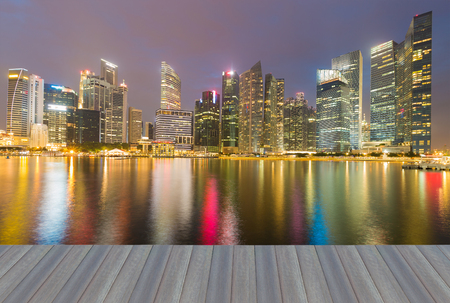 Opening wooden floor, Night reflection light Singapore city office building downtown sea frontの写真素材
