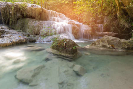 Tropical deep forest waterfall, natural landscape backgroundの写真素材