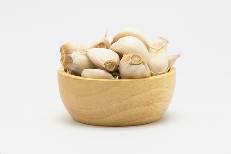 Fresh Garlic on wooden bowl, Raw Garlic on white backgroundの写真素材