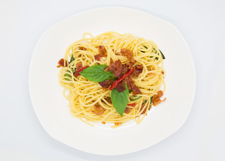 Homemade spaghetti top view, on white backgroundの写真素材