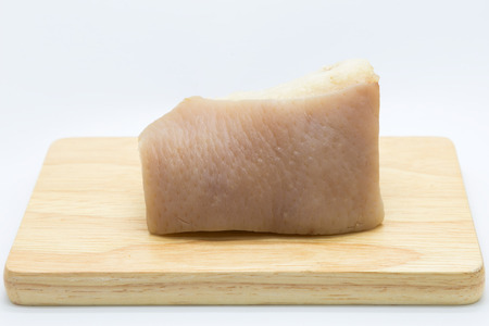 Boiled skin poark on wooden board, on white backgroundの写真素材