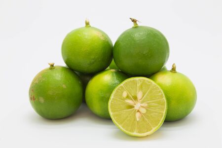 Fresh limes on white background, isolated fruitの写真素材
