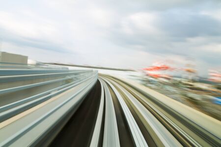 Moving blurred motion track curved into city downtown, abstract backgroundの写真素材