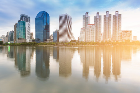 City office building with water reflection in public park, cityscape backgroundの写真素材