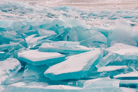 Ice cracked over Baikal water lake in winter season natural landscape background