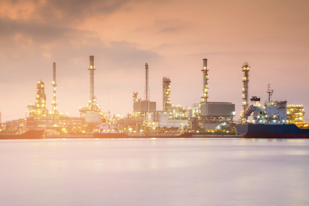 Chemical refinery water front during sunrise, industrial backgroundの写真素材