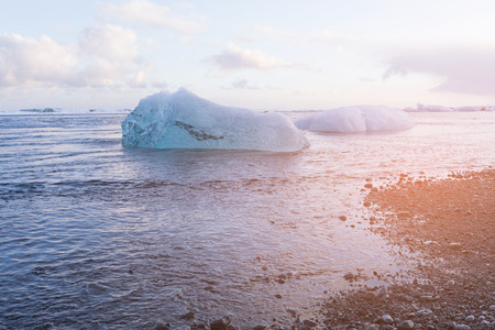 Diamond ice over black sand beach, Jokulsarlon glacier, Iceland winter season natural landscape backgroundの写真素材