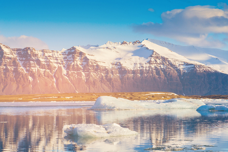 Iceland reflection lake with black volcano mountain, winter season natural landscape backgroundの写真素材