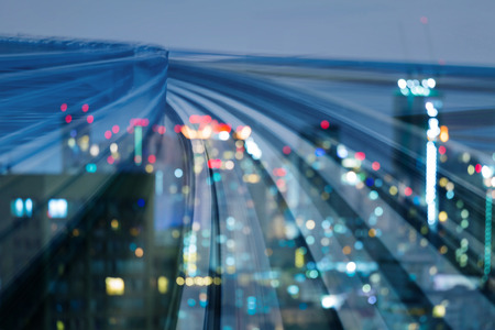 Abstract bokeh light city downtown over motion train track backgroundの写真素材
