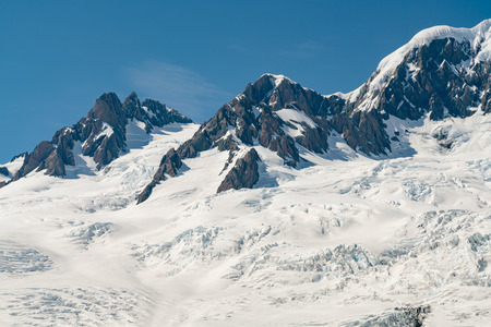 Black rock mountain with snow covered, New Zealand natural landscape backgroundの写真素材