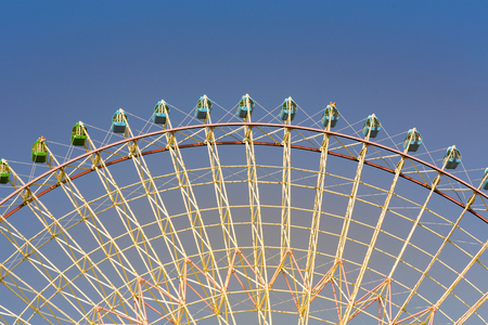 Bottom view giant ferris wheel with clear blue sky backgroundの写真素材