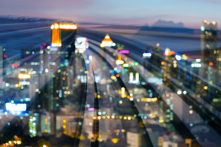 Blur bokeh light city downtown over train track motion curved, abstract backgroundの写真素材