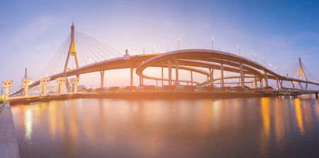 Panorama highway intersection connect with suspension bridge river front and reflectionの写真素材