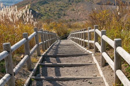 Wooden stair leading down to mountain slope, Japand natural landscape backgroundの写真素材