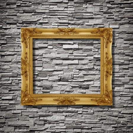 antique frame on stone wall backgroundの写真素材