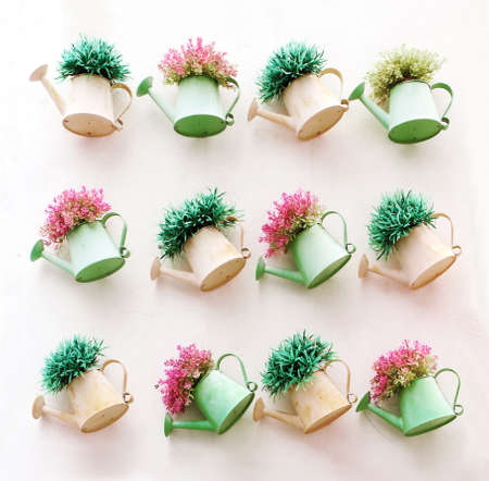 Artificial colorful flowers pots hang onto the wall