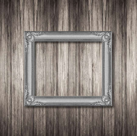 Silver frame on wooden wall
