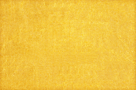 Shiny yellow leaf gold foil texture backgroundの写真素材
