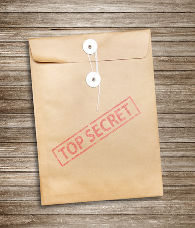 Top Secret package on wood background