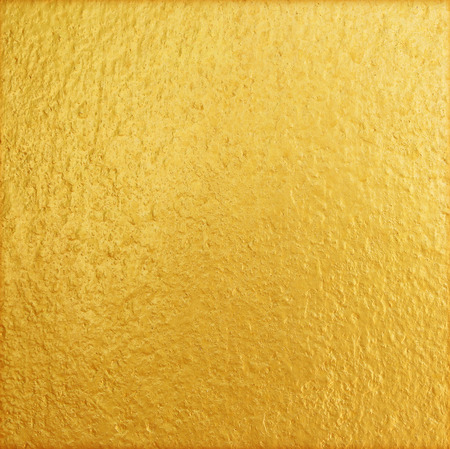 Shiny yellow gold wall texture backgroundの写真素材