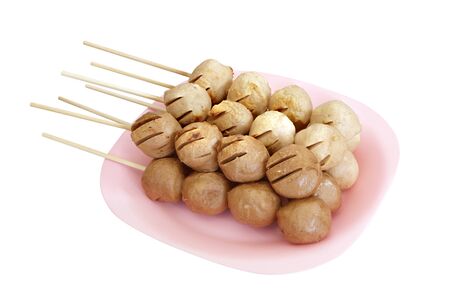 Meatball skewers grill on plate isolated on whiteの写真素材