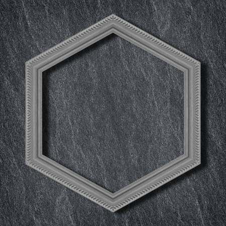 gray wooden hexagonal frame isolated on  on Dark grey black slate background or texture background.の写真素材