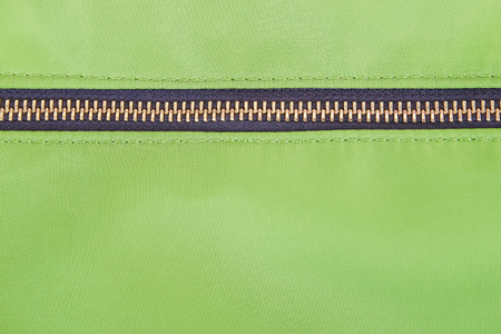 Green cloth and zipper texture backgroundの写真素材