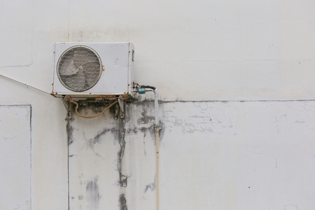 Old condensing unit for Air Conditioner on the wallの写真素材