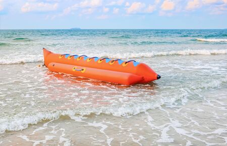 Colorful banana boat floating near the shore