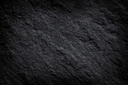 Dark grey stone or black slate stone background or textureの写真素材