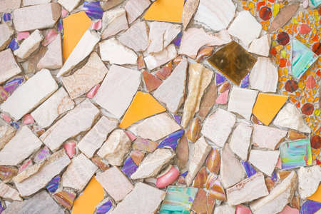 The cement walls are decorated with color stone and scrap  tile  texture backgroundの写真素材
