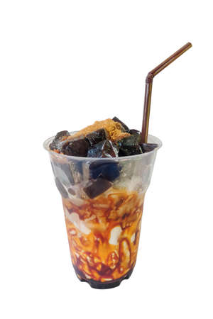 Honey and milk ,Brown sugar mix grass Jelly in plastic glass isolated on white backgroundの写真素材