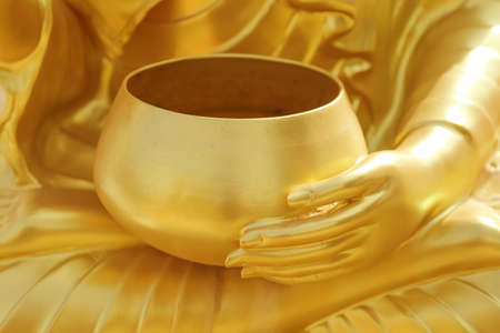Stucco gold of Statue of Hand of buddha statue holding monk's bowl ,Believe Culture. Buddhist...