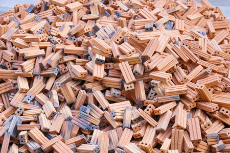 A pile of building materials, stack of new red bricks for construction